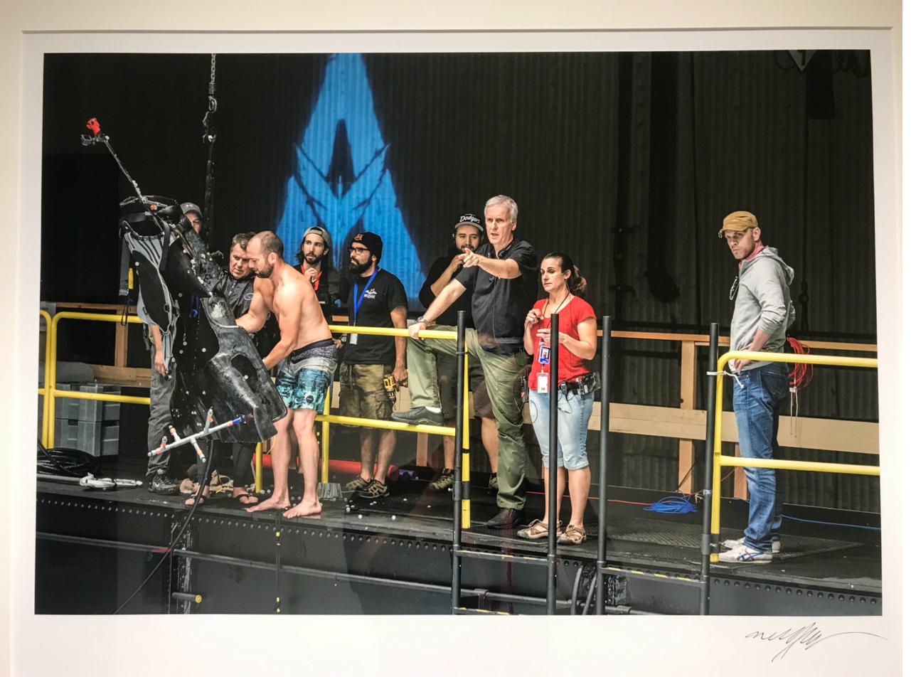 Signed print of James Cameron directing at the water tank stage with the Avatar logo behind him