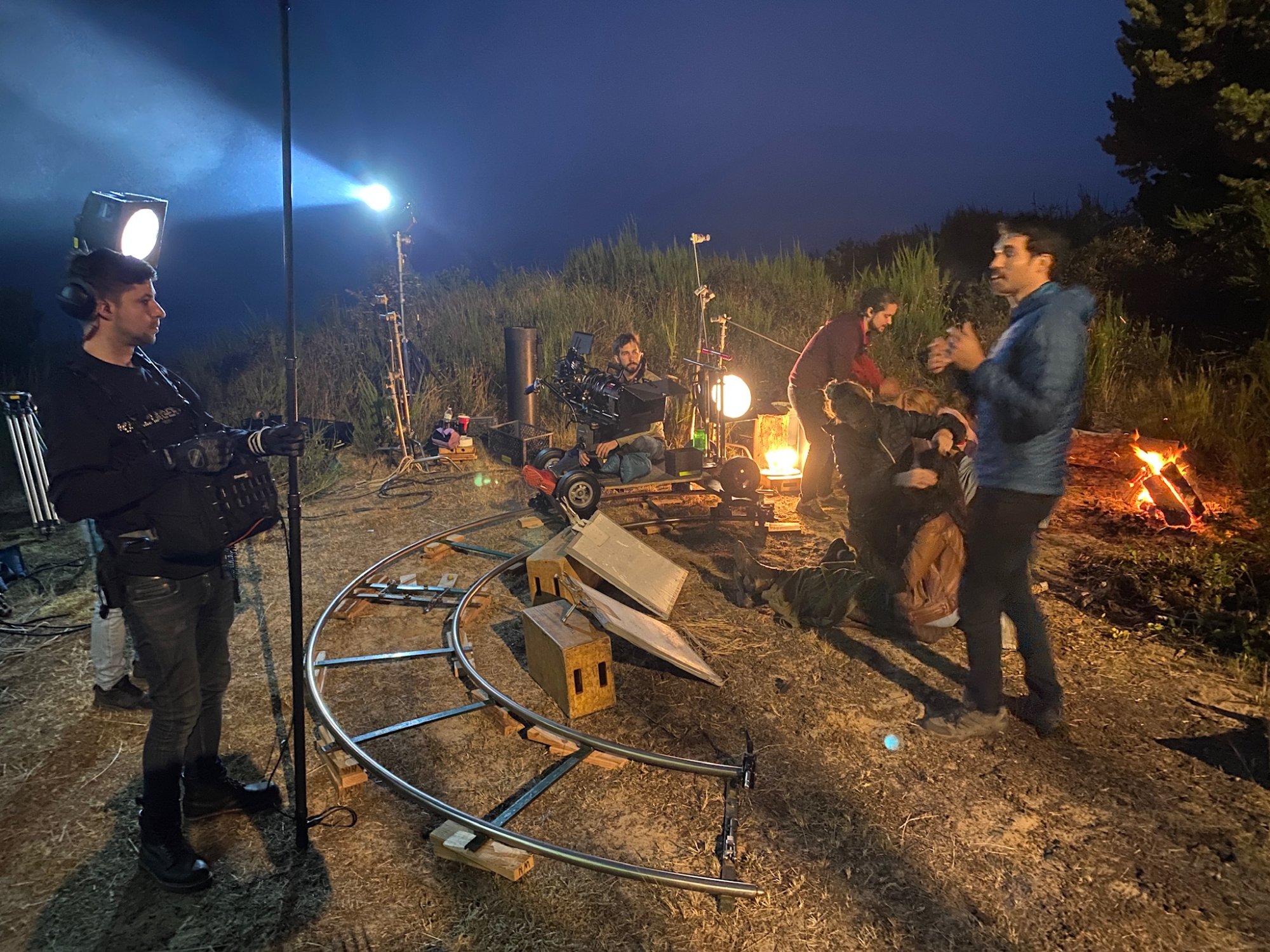 Night exterior setup with curved dolly track and campfire