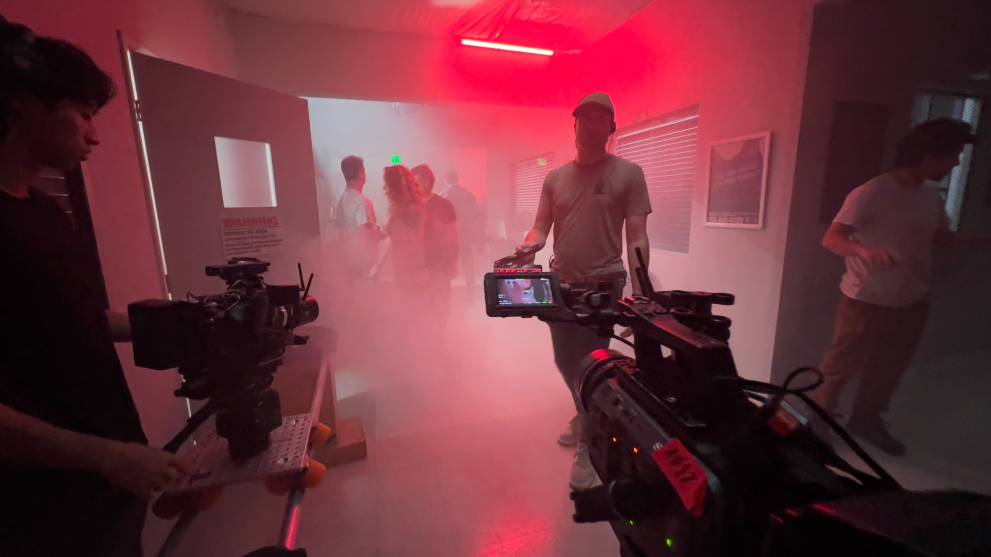 Behind the scenes — multicam setup in the red-lit hospital corridor with haze