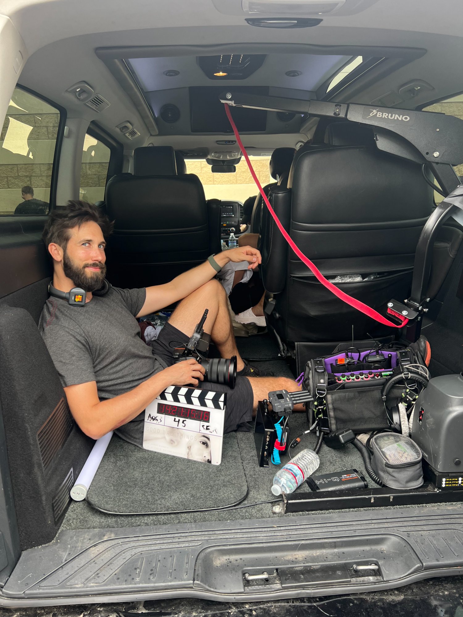 Nathan in the back of Danny's wheelchair-accessible van with the slate and sound gear — the entire department fits in one vehicle