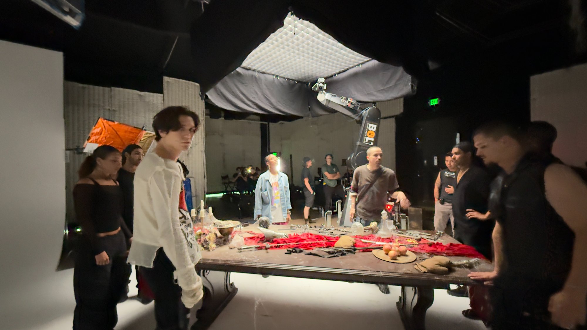 The Bolt motion control arm positioned over the table set with cast standing around it — pre-programmed moves ready to fire